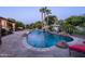 Gorgeous pool with waterfall feature, stone coping, and mature landscaping at 2107 E Park Ave, Gilbert, AZ 85234