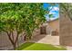 Cozy backyard featuring a lemon tree, artificial grass, gravel and a privacy fence at 2327 E Meadow Creek Way, San Tan Valley, AZ 85140