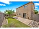 Spacious backyard featuring artificial turf, pavers, desert landscaping and a view of the two-story home at 2327 E Meadow Creek Way, San Tan Valley, AZ 85140