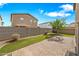 View of a backyard featuring a grassy area, stone pavers, privacy fence, and a two-story home at 2327 E Meadow Creek Way, San Tan Valley, AZ 85140