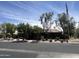 Exterior view of community clubhouse with well-manicured landscaping and a flag pole at 2327 E Meadow Creek Way, San Tan Valley, AZ 85140