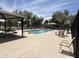 Community pool area with seating, picnic tables and shaded seating areas at 2327 E Meadow Creek Way, San Tan Valley, AZ 85140