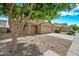 Charming two-story home featuring a two-car garage, low-maintenance desert landscaping, and a shady tree at 2327 E Meadow Creek Way, San Tan Valley, AZ 85140
