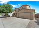 Charming two-story home with desert landscaping, two car garage, and a beautiful green tree in the front yard at 2327 E Meadow Creek Way, San Tan Valley, AZ 85140