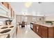 Open kitchen offers white appliances, brown cabinets and view of the dining area at 2327 E Meadow Creek Way, San Tan Valley, AZ 85140