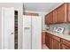 Bright kitchen view with stainless refrigerator, pantry, and wooden cabinets at 2327 E Meadow Creek Way, San Tan Valley, AZ 85140