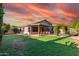 Inviting backyard with lush green lawn, covered patio, and charming garden archway at 2343 E Morelos St, Chandler, AZ 85225