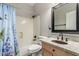 Cozy bathroom featuring a bathtub and shower combo, as well as a decorative copper sink at 2343 E Morelos St, Chandler, AZ 85225