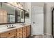 Bathroom with double sink vanity with granite countertop and wood cabinets at 2343 E Morelos St, Chandler, AZ 85225