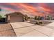 A single-story home featuring a desert landscape, two-car garage, and a long driveway at 2343 E Morelos St, Chandler, AZ 85225