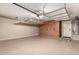 Spacious garage with storage cabinets, high ceiling with shelving, and epoxy-coated floor at 2343 E Morelos St, Chandler, AZ 85225