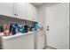 Well-organized laundry room with ample storage cabinets and modern washer and dryer at 2343 E Morelos St, Chandler, AZ 85225