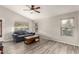 Bright living room with wood-look tile flooring, a vaulted ceiling, and lots of natural light at 2343 E Morelos St, Chandler, AZ 85225