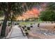Park with a walking path on manicured grounds featuring an gazebo, landscaping and a beautiful sunset background at 2343 E Morelos St, Chandler, AZ 85225