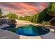 Backyard swimming pool offers a relaxing escape with clear water and landscaped surroundings at 2343 E Morelos St, Chandler, AZ 85225