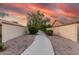 A walkway lined with landscaping, providing a picturesque path with a vibrant sunset backdrop at 2343 E Morelos St, Chandler, AZ 85225