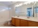 Bathroom with double sink vanity, shower-tub combo and large mirror at 2421 W Indigo Dr, Chandler, AZ 85248