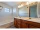 Bathroom features a double sink vanity and shower-tub combination at 2421 W Indigo Dr, Chandler, AZ 85248