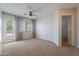 Bright bedroom with neutral carpet, ceiling fan, and access to private balcony at 2421 W Indigo Dr, Chandler, AZ 85248