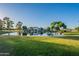 Scenic view of the community lake surrounded by beautiful homes and lush greenery at 2421 W Indigo Dr, Chandler, AZ 85248