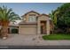 Charming two-story home boasts a well-manicured lawn, mature palm trees and a covered entryway at 2421 W Indigo Dr, Chandler, AZ 85248