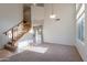 Inviting foyer with hardwood staircase, tile floors, neutral walls, and large windows at 2421 W Indigo Dr, Chandler, AZ 85248
