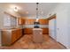 Bright kitchen featuring wood cabinets, stainless steel appliances, and a center island at 2421 W Indigo Dr, Chandler, AZ 85248