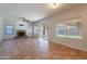 Spacious living room with tile floors, fireplace, fan and natural light from the windows at 2421 W Indigo Dr, Chandler, AZ 85248