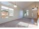 Bright living room with vaulted ceilings, carpet, tile entryway, and multiple large windows at 2421 W Indigo Dr, Chandler, AZ 85248