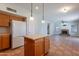 Open concept kitchen and living room with tile flooring and stone fireplace at 2421 W Indigo Dr, Chandler, AZ 85248