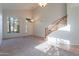 Bright living room with vaulted ceilings, staircase, tile entryway, and multiple large windows at 2421 W Indigo Dr, Chandler, AZ 85248