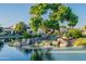 Picturesque water feature with a charming waterfall, mature trees, and lush landscaping at 2421 W Indigo Dr, Chandler, AZ 85248