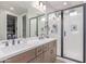 Modern bathroom featuring double sinks and a walk-in glass shower at 2499 S Entwistle St, Gilbert, AZ 85295