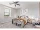 Cozy bedroom featuring a black metal bed frame, soft carpet, ceiling fan, and natural light at 2499 S Entwistle St, Gilbert, AZ 85295