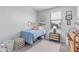 Cozy bedroom featuring a single bed, soft carpet, and decorated walls at 2499 S Entwistle St, Gilbert, AZ 85295