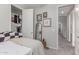 Relaxing bedroom with decor, full-length mirror, and open closet with organized storage and interior access at 2499 S Entwistle St, Gilbert, AZ 85295