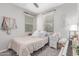 Comfortable bedroom with a single bed, soft carpet, and a ceiling fan at 2499 S Entwistle St, Gilbert, AZ 85295