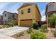 Two-story home with a welcoming facade, attached garage, driveway, and colorful landscape at 2499 S Entwistle St, Gilbert, AZ 85295