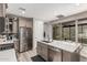 This modern kitchen features stainless steel appliances and a large island with white countertops at 2499 S Entwistle St, Gilbert, AZ 85295