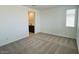 Spacious bedroom featuring neutral paint, carpet, and a window providing ample natural light at 25137 W Wayland Dr, Buckeye, AZ 85326