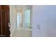 Bright hallway featuring neutral paint, tile flooring, and an open floor plan at 25137 W Wayland Dr, Buckeye, AZ 85326