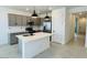 Modern kitchen featuring gray cabinets, stainless steel appliances, and a kitchen island at 25137 W Wayland Dr, Buckeye, AZ 85326