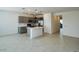 Bright, open-concept kitchen with gray cabinets, stainless steel appliances, and spacious tile flooring at 25137 W Wayland Dr, Buckeye, AZ 85326