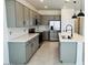 Modern kitchen featuring gray cabinets, stainless steel appliances, and a kitchen island at 25137 W Wayland Dr, Buckeye, AZ 85326