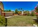 Expansive back yard with lush lawn, patio, carport, and mature landscaping at 28 E 14Th St, Tempe, AZ 85281