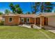 Back yard features a covered patio, green lawn, and lush landscaping, perfect for outdoor enjoyment at 28 E 14Th St, Tempe, AZ 85281