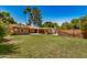 Expansive backyard featuring a lush lawn, mature trees, covered patio, and brick accents at 28 E 14Th St, Tempe, AZ 85281