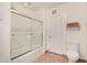 Clean, white bathroom features a shower with glass door and neutral tile flooring at 28 E 14Th St, Tempe, AZ 85281