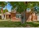 Charming brick home is surrounded by mature trees and a lush green lawn at 28 E 14Th St, Tempe, AZ 85281
