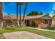 Inviting brick home boasts a terracotta tile roof, lush lawn, and mature shade trees at 28 E 14Th St, Tempe, AZ 85281